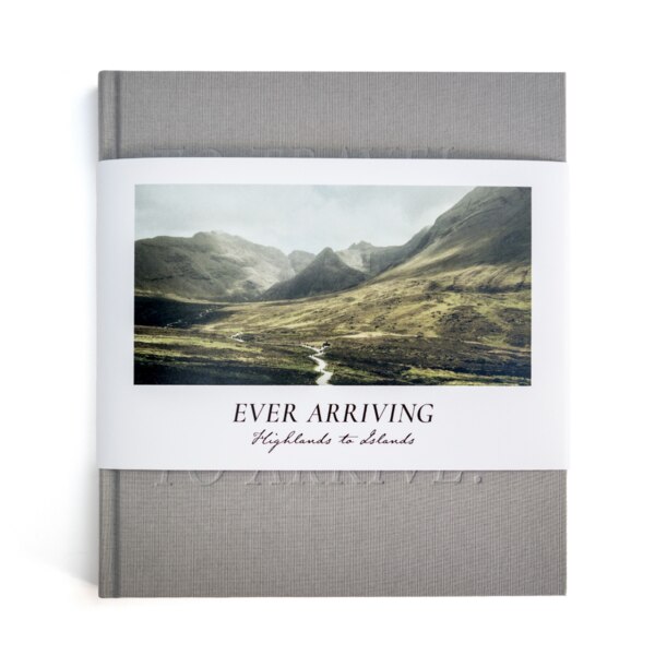 Front cover of the book "Ever Arriving Highlands to Islands" featuring a half dust cover with a landscape image of a valley and mountains